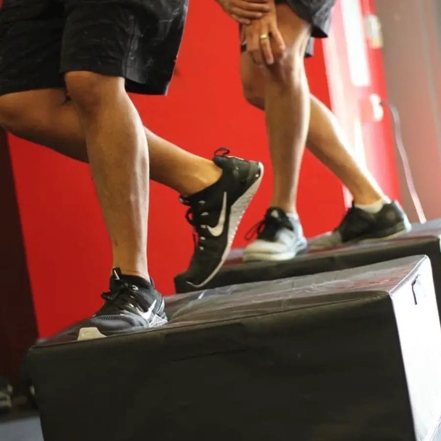 Athlete performing box jump exercise during a workout at Jute CrossFit
