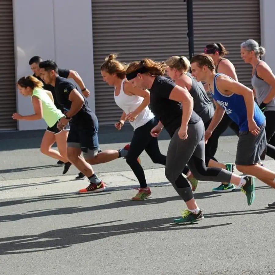 Group fitness training session at Jute CrossFit with athletes running outdoors