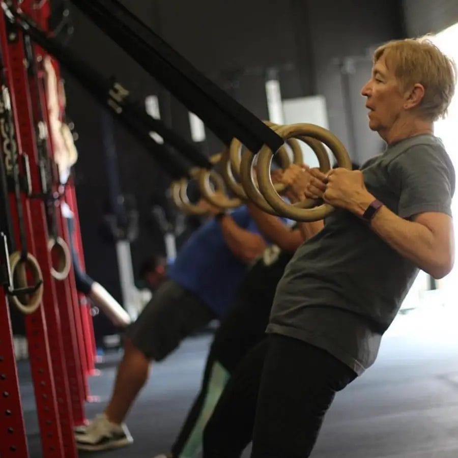 Member doing ring training exercise inside Jute CrossFit gym